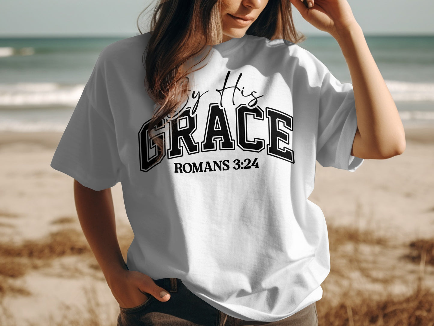 By His Grace Romans 3:24 Graphic Tee product